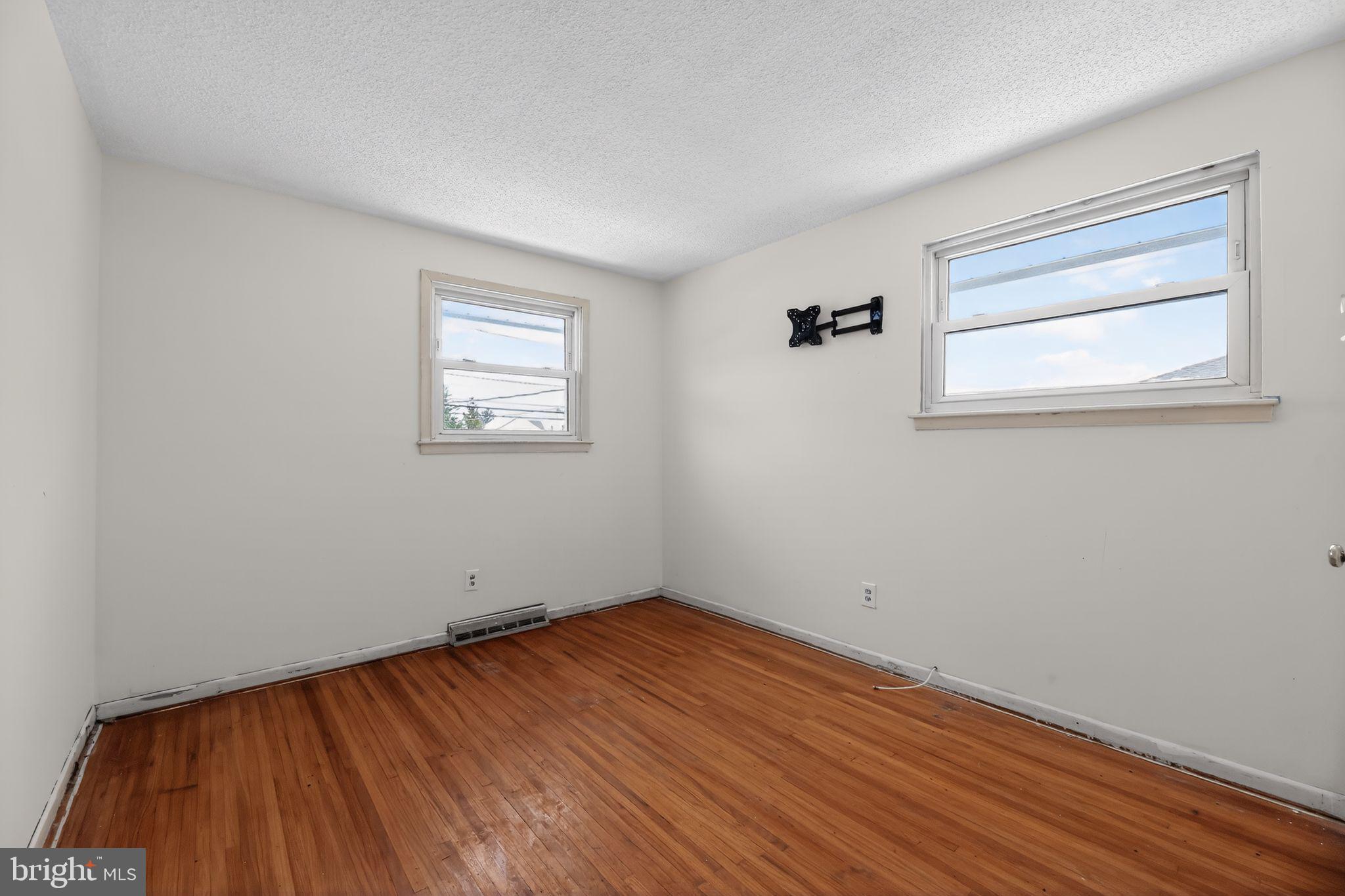308 Smith Lane Runnemede, NJ 08078 - Photo 25 of 32 an empty room with wooden floor and windows