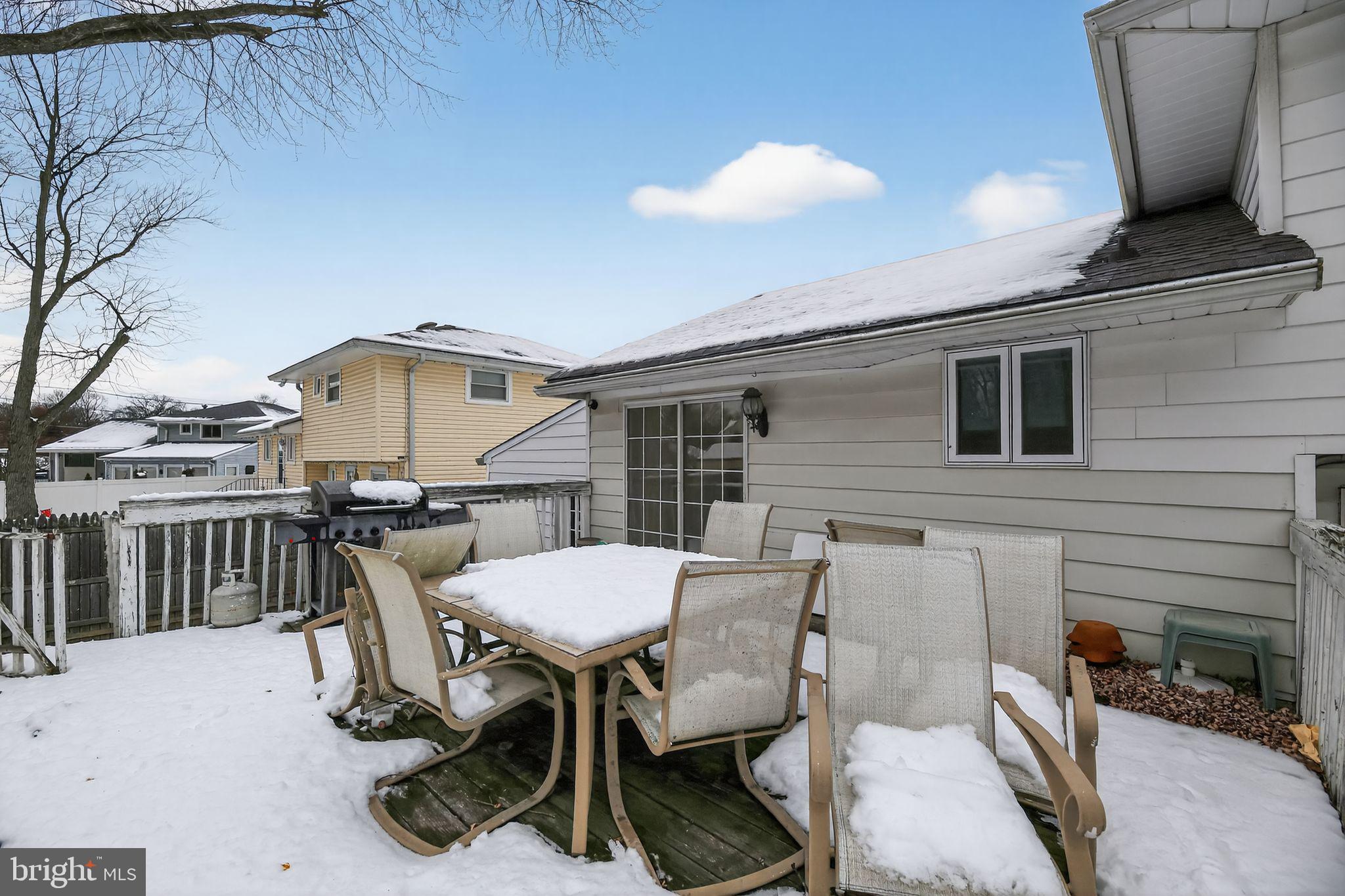 308 Smith Lane Runnemede, NJ 08078 - Photo 27 of 32 a view of a patio with table and chairs a barbeque with wooden floor and fence