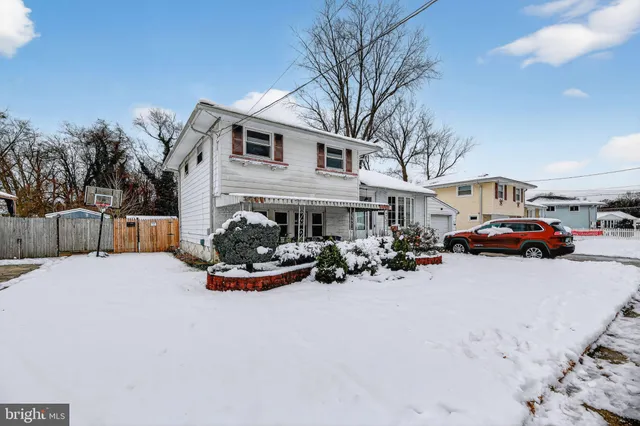 a view of a house with a yard covered with snow in front of house