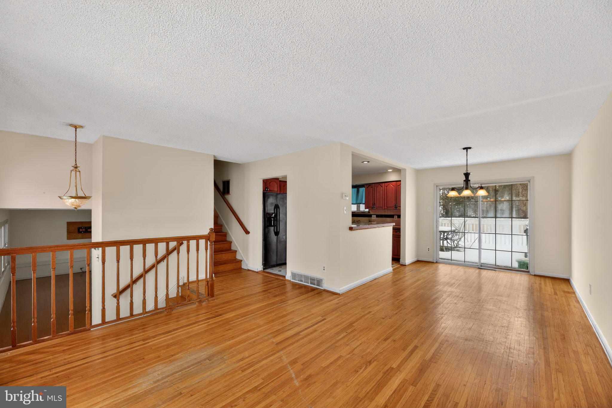 308 Smith Lane Runnemede, NJ 08078 - Photo 5 of 32 a view of a livingroom with wooden floor and a kitchen space