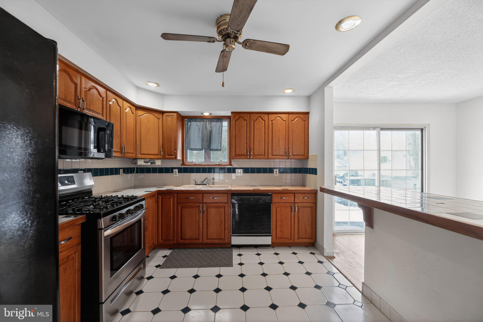 308 Smith Lane Runnemede, NJ 08078 - Photo 8 of 32 a kitchen with stainless steel appliances granite countertop a stove a sink and a microwave