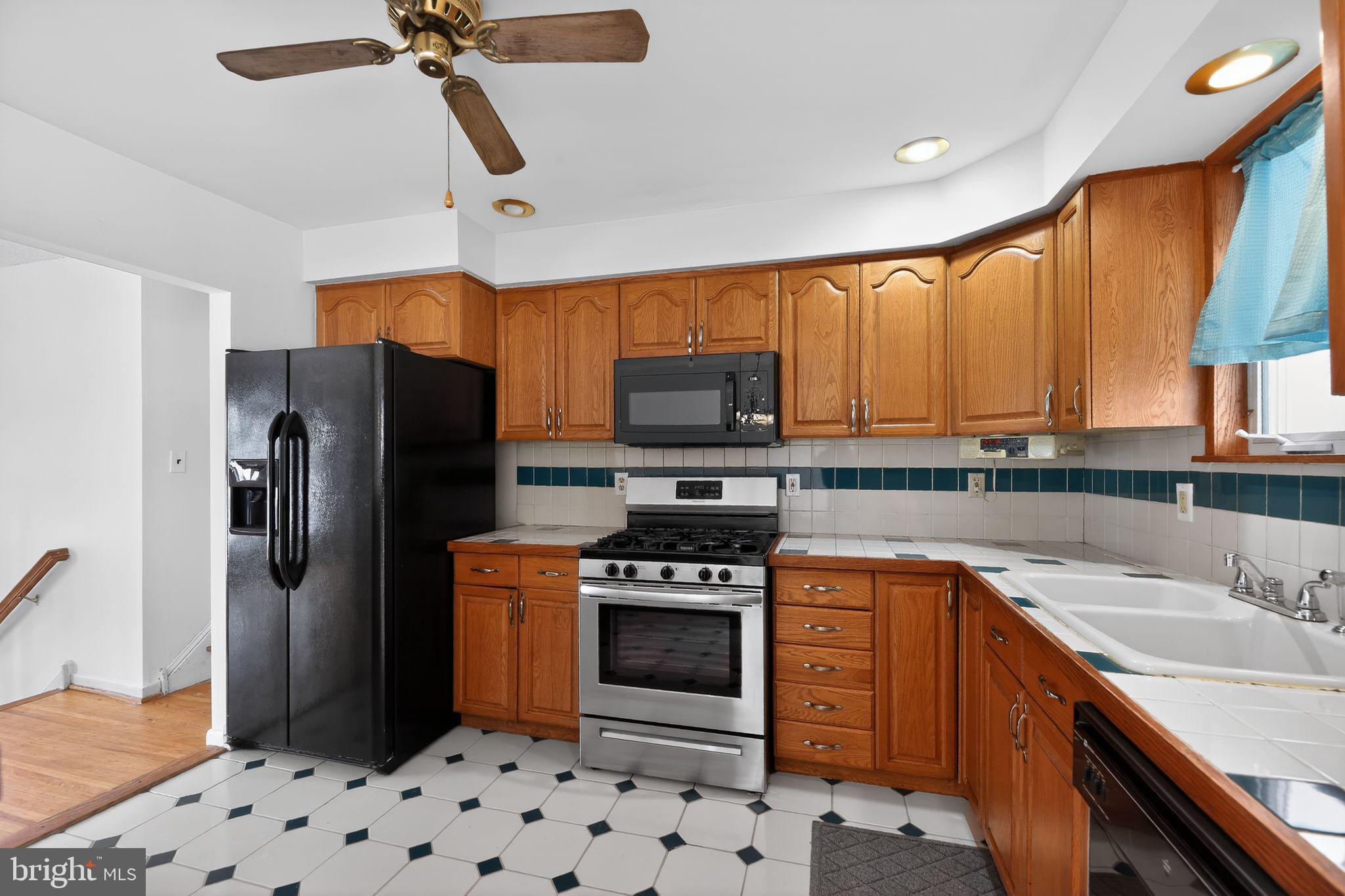 308 Smith Lane Runnemede, NJ 08078 - Photo 9 of 32 a kitchen with stainless steel appliances a stove a sink and a refrigerator