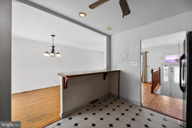 a view of a kitchen with a sink and wooden floor