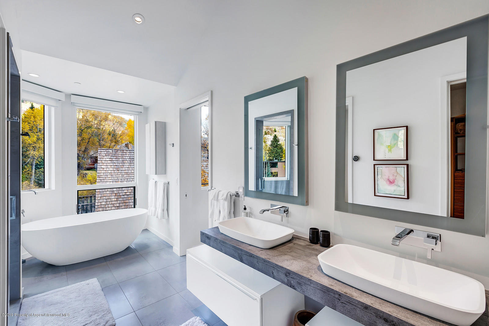 1098 Waters Avenue Aspen, CO 81611 - Photo 22 of 45 a bathroom with double vanity sinks a tub and a mirror