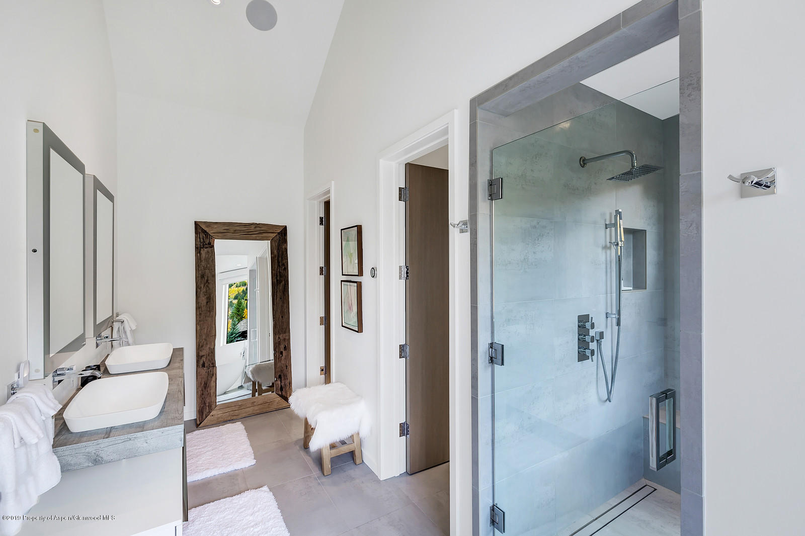 1098 Waters Avenue Aspen, CO 81611 - Photo 23 of 45 a bathroom with a granite countertop sink mirror and shower
