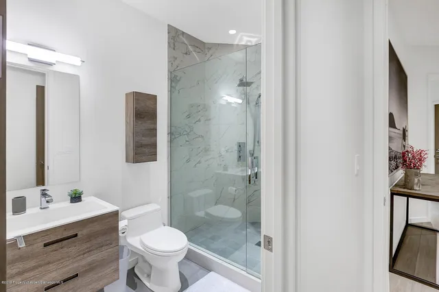 a bathroom with a sink toilet and shower