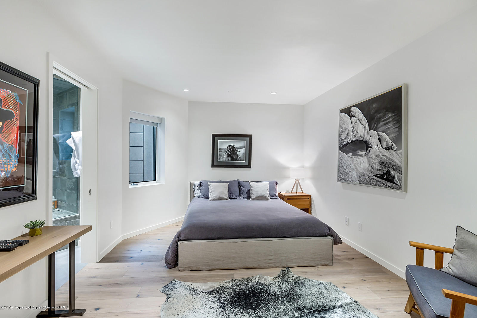 1098 Waters Avenue Aspen, CO 81611 - Photo 34 of 45 a bedroom with a large bed and a couch