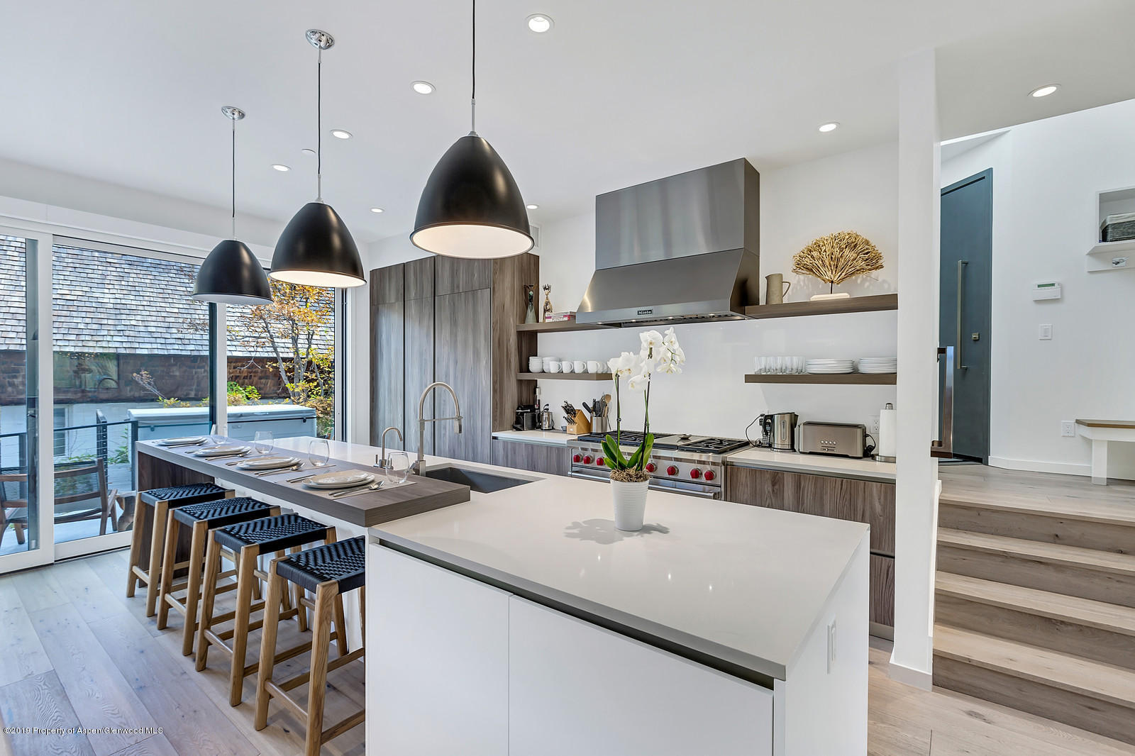 1098 Waters Avenue Aspen, CO 81611 - Photo 6 of 45 a kitchen with stainless steel appliances granite countertop a sink a stove and a wooden floors
