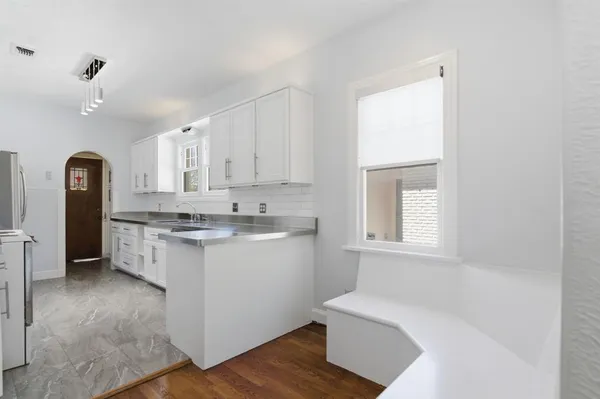 a utility room with cabinets washer and dryer