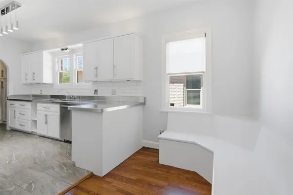 a kitchen with stainless steel appliances granite countertop a sink a stove and a refrigerator