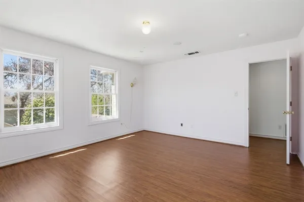 an empty room with wooden floor