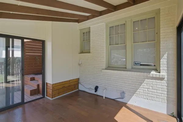a view of a porch with wooden floor and outdoor space