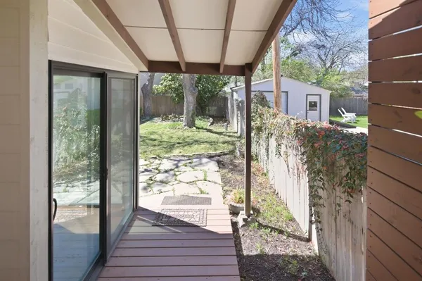 a view of house with backyard and a tree
