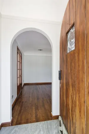 a view of a hallway with wooden floor