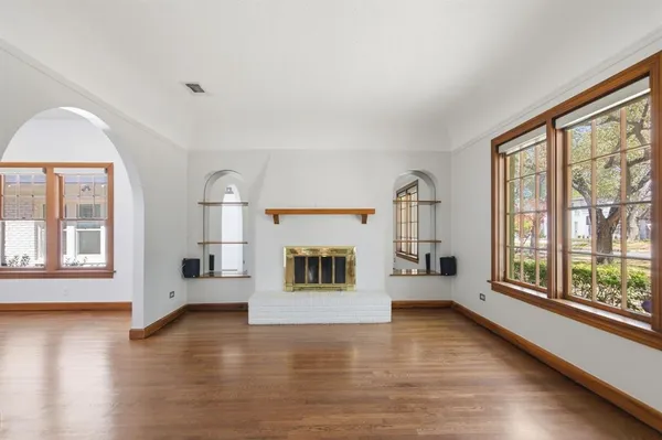 a view of a room with wooden floor and a window