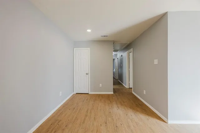 a view of hallway with wooden floor
