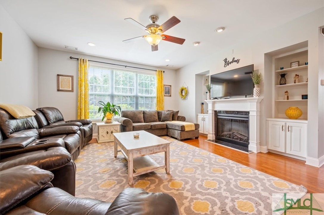 111 Stadium Drive Guyton, GA 31312 - Photo 17 of 50 Great Room ~ Wood Floors ~ Electric Fireplace ~ Cu