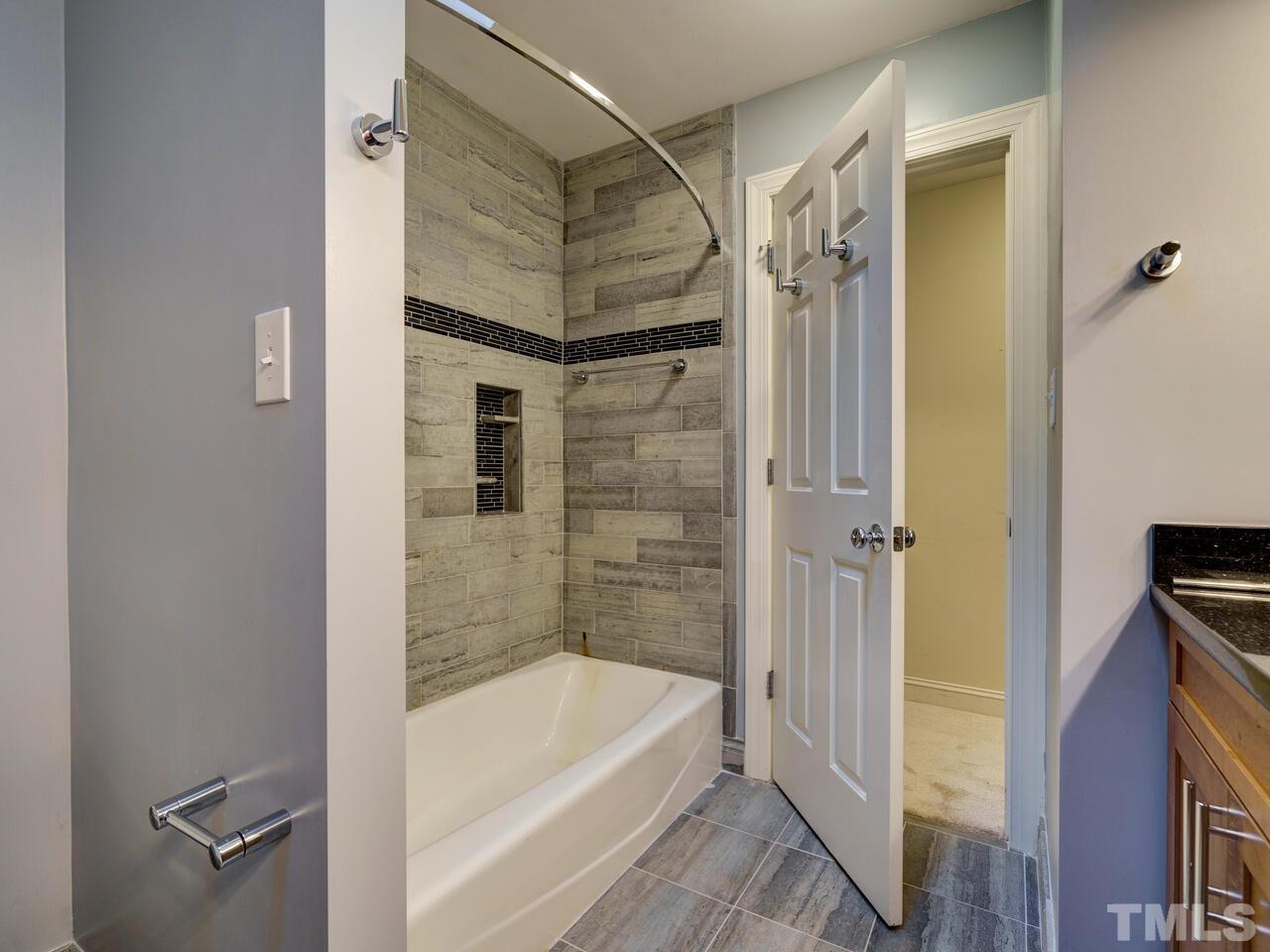 7721 Sandy Bottom Way Raleigh, NC 27613 - Photo 22 of 39 a bathroom with a bathtub and a shower