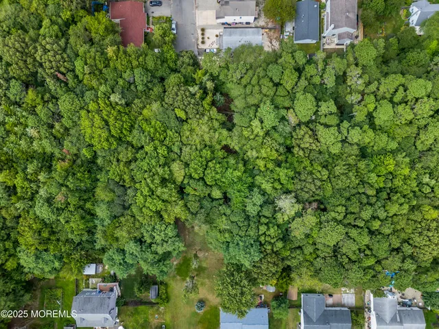 a backyard of a house with lots of green space and a fountain