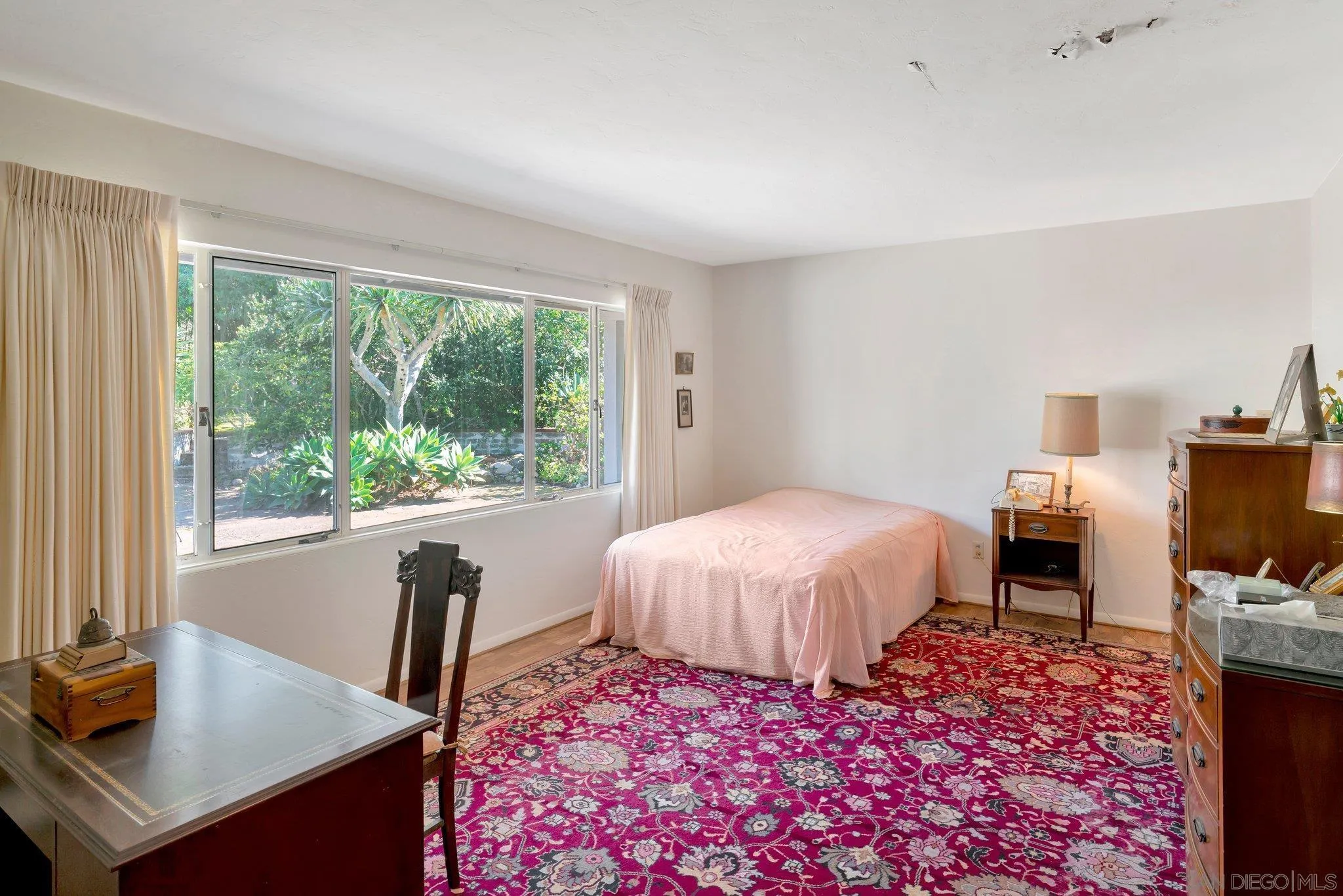 1351 Rhoda Drive La Jolla, CA 92037 - Photo 16 of 20 a bedroom with a bed and a table in it