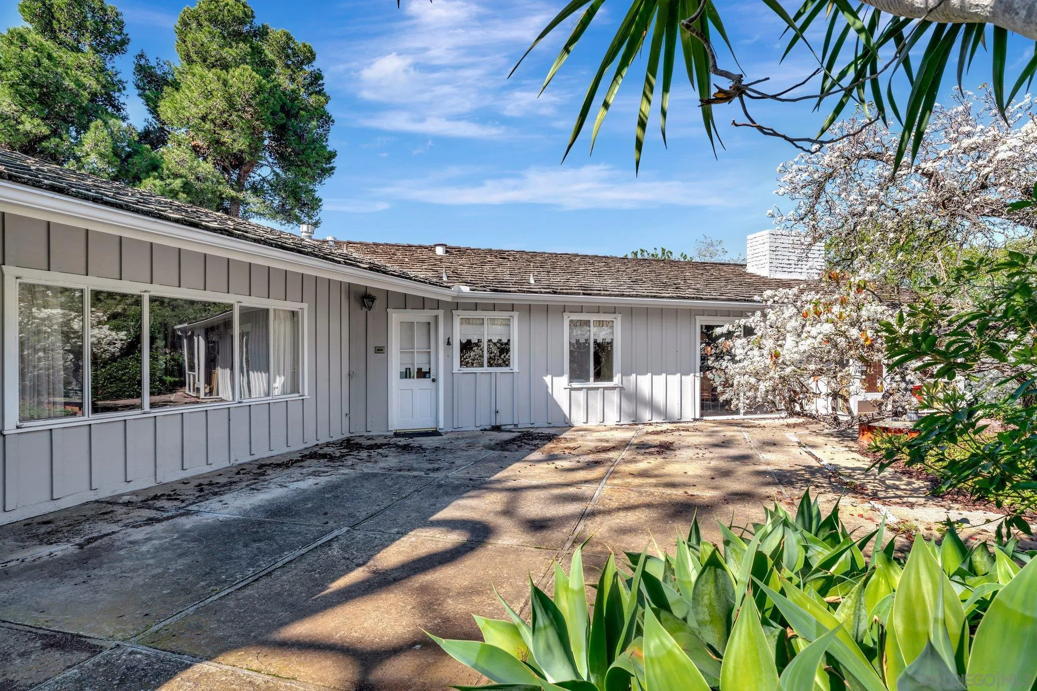 1351 Rhoda Drive La Jolla, CA 92037 - Photo 8 of 20 a front view of a house with a yard