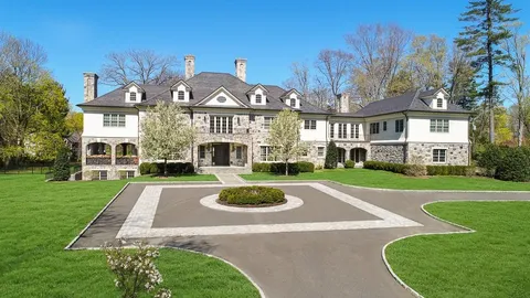a view of a big building with a big yard and potted plants