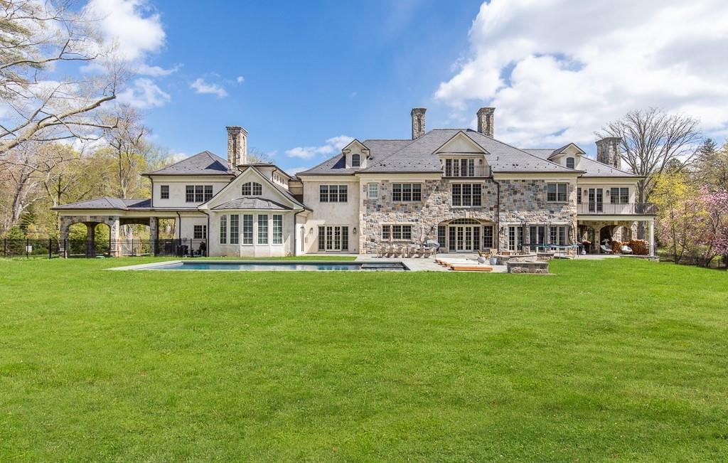 1 Duck Pond Road Scarsdale, NY 10583 - Photo 45 of 48 a front view of a house with a garden