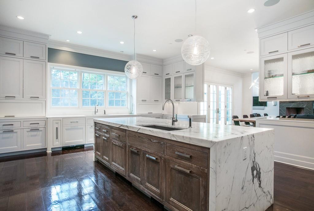1 Duck Pond Road Scarsdale, NY 10583 - Photo 7 of 48 a kitchen with stainless steel appliances a sink stove and cabinets