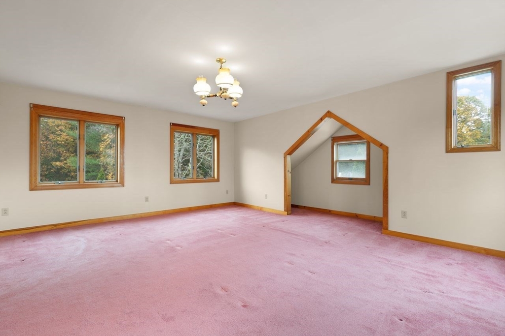 10 Oak Street Wareham, MA 02571 - Photo 16 of 39 an empty room with windows and chandelier fan