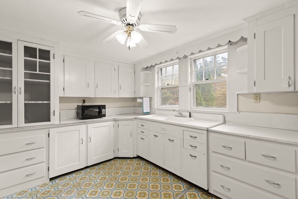 10 Oak Street Wareham, MA 02571 - Photo 5 of 39 a kitchen with white cabinets and window