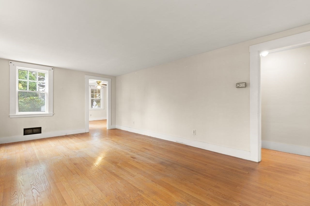 10 Oak Street Wareham, MA 02571 - Photo 8 of 39 an empty room with wooden floor and windows