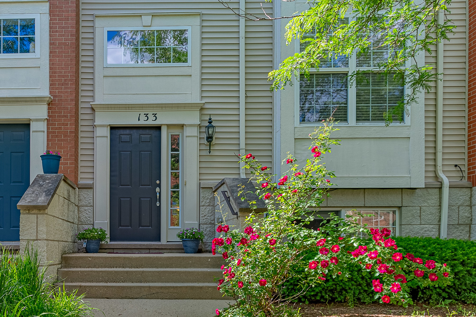 a front view of a house with flowers