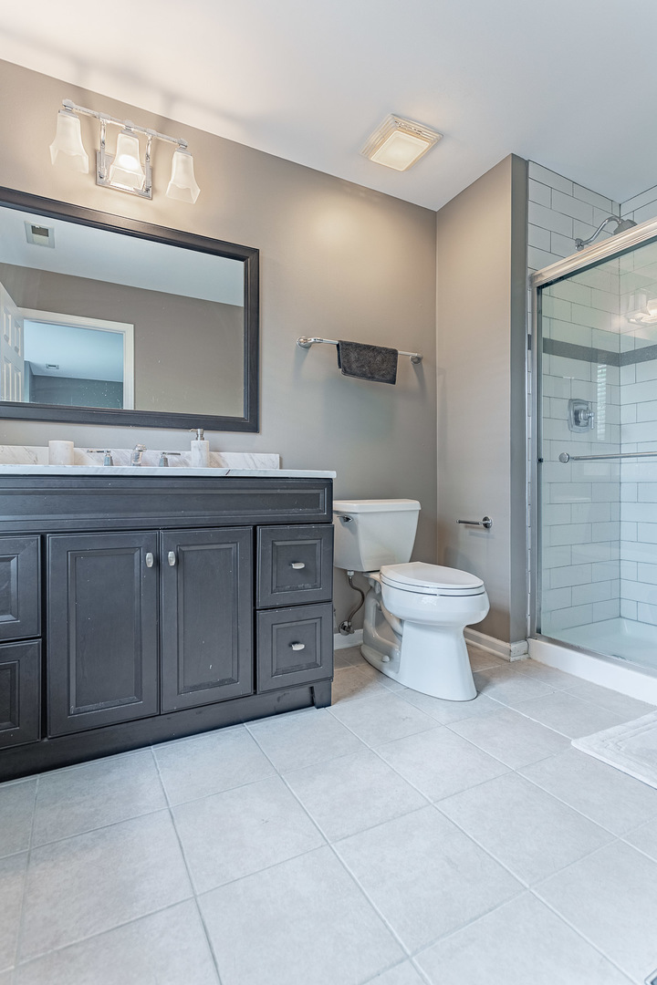 133 Willey Street Gilberts, IL 60136 - Photo 12 of 21 a bathroom with a toilet sink and mirror