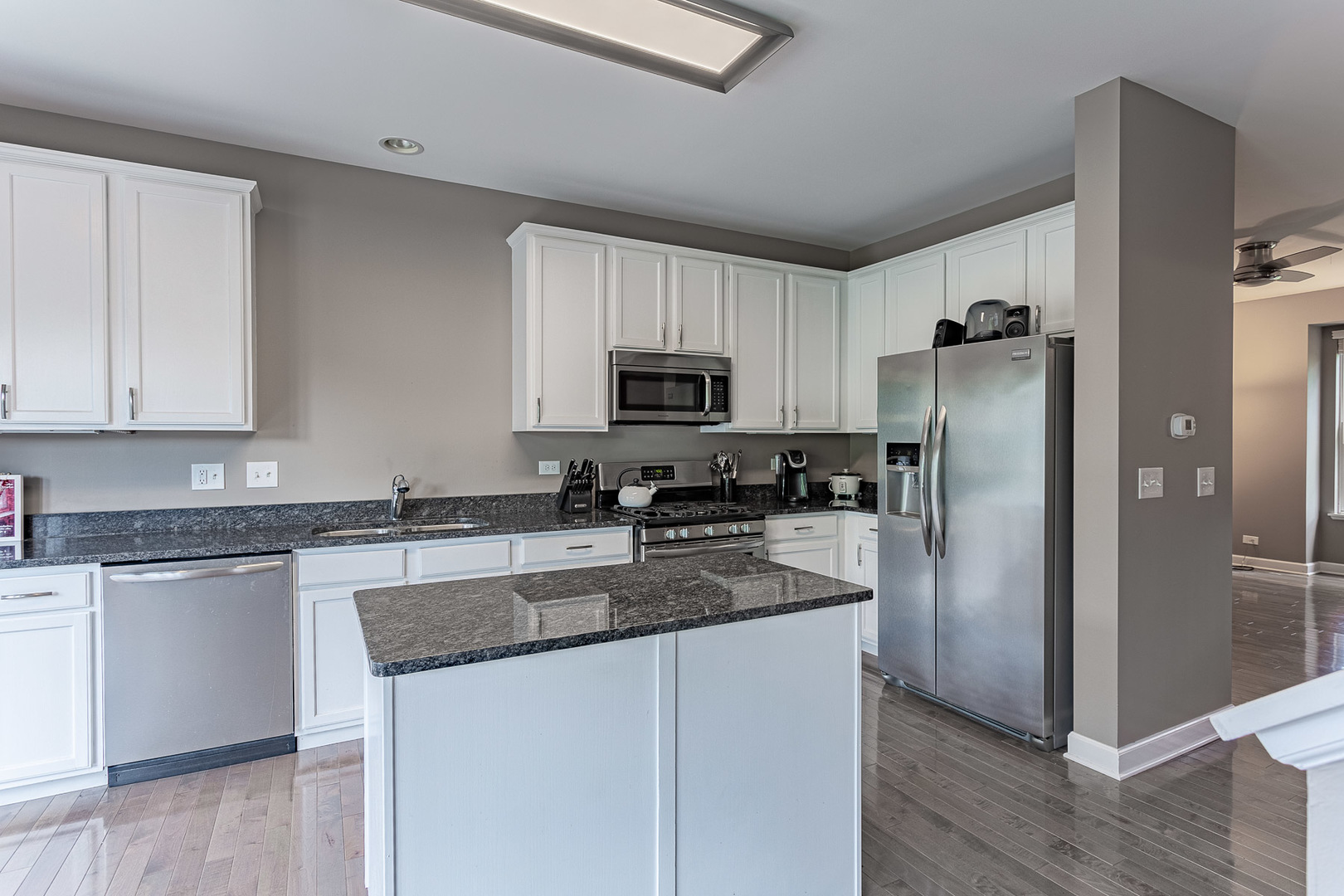 133 Willey Street Gilberts, IL 60136 - Photo 3 of 21 a kitchen with granite countertop a refrigerator and a stove top oven