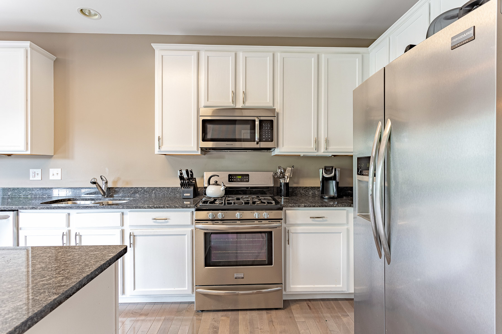 133 Willey Street Gilberts, IL 60136 - Photo 4 of 21 a kitchen with stainless steel appliances granite countertop a stove a refrigerator and a sink
