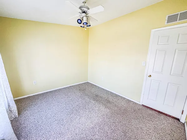 a view of empty room with a fan