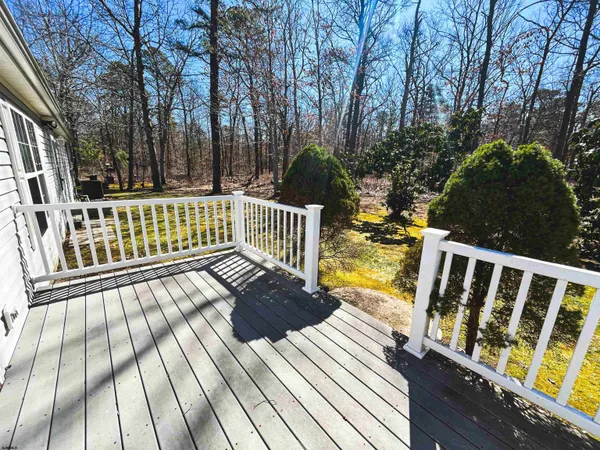 a view of balcony with wooden floor and fence