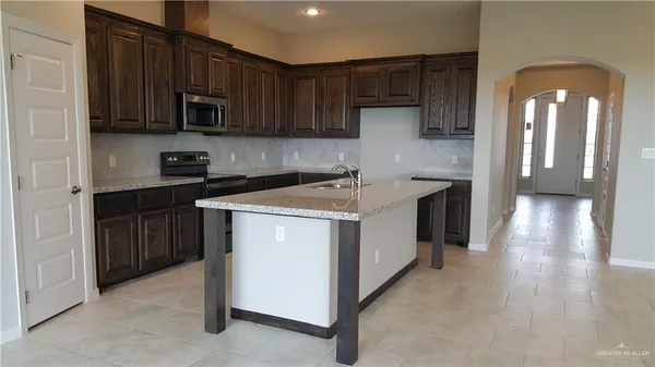 a kitchen with a sink stove and cabinets