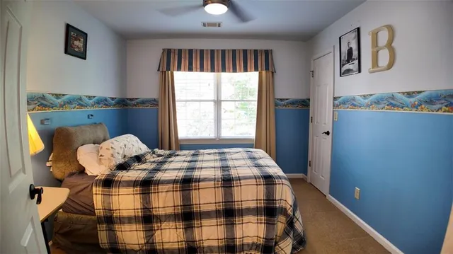 a bedroom with bed and window