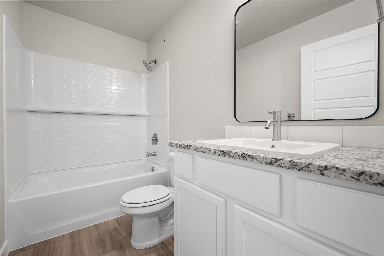5516 Princeton Street Lubbock, TX 79416 - Photo 13 of 17 a bathroom with a granite countertop sink toilet and shower