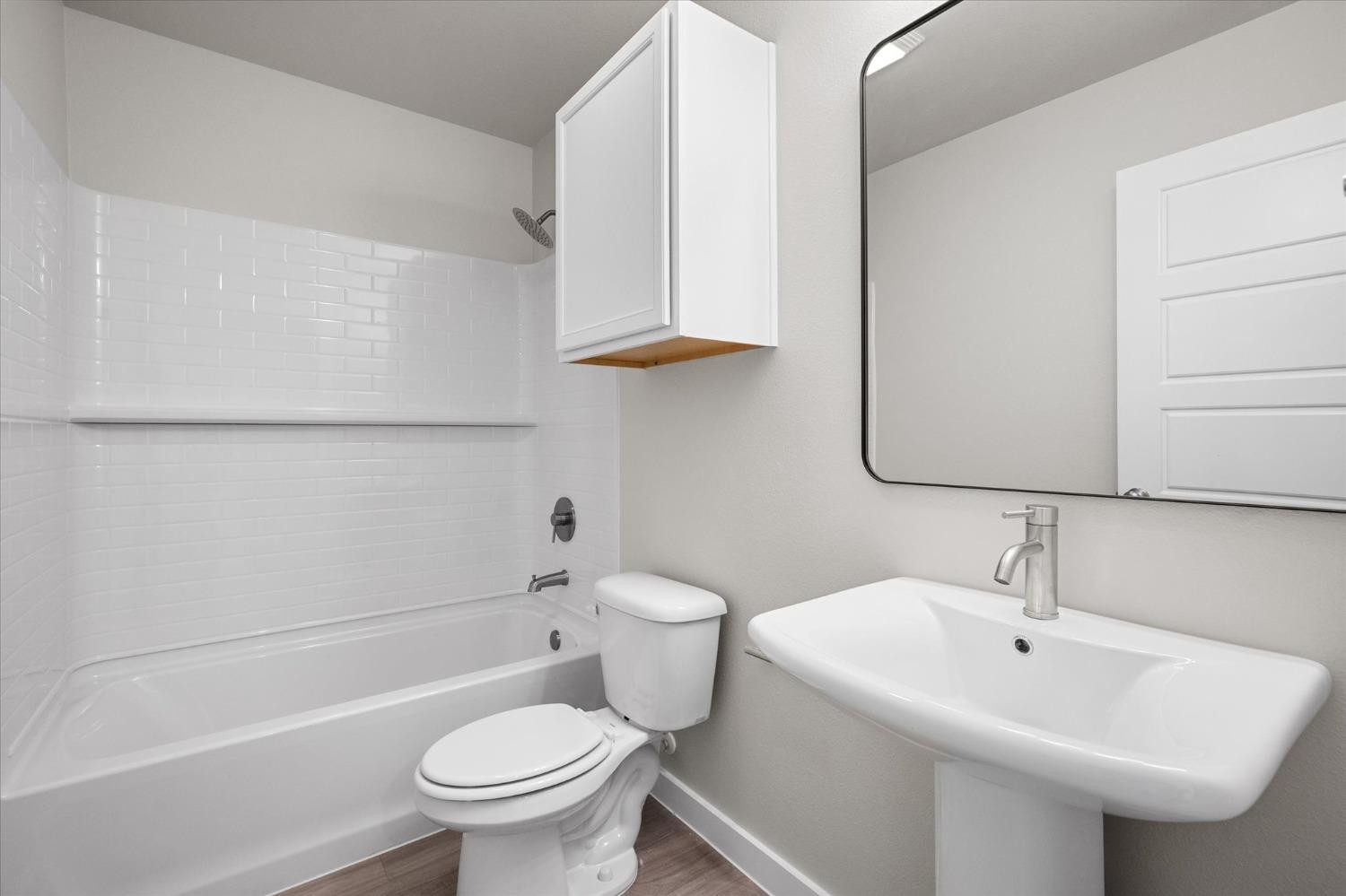 5516 Princeton Street Lubbock, TX 79416 - Photo 15 of 17 a bathroom with a sink a toilet and vanity