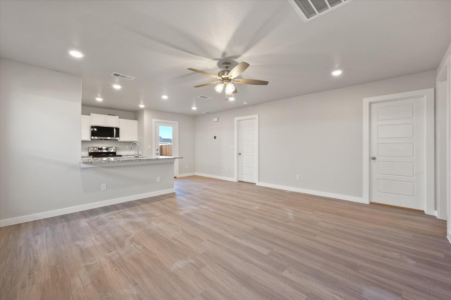 5516 Princeton Street Lubbock, TX 79416 - Photo 4 of 17 a view of kitchen with ceiling fan and window