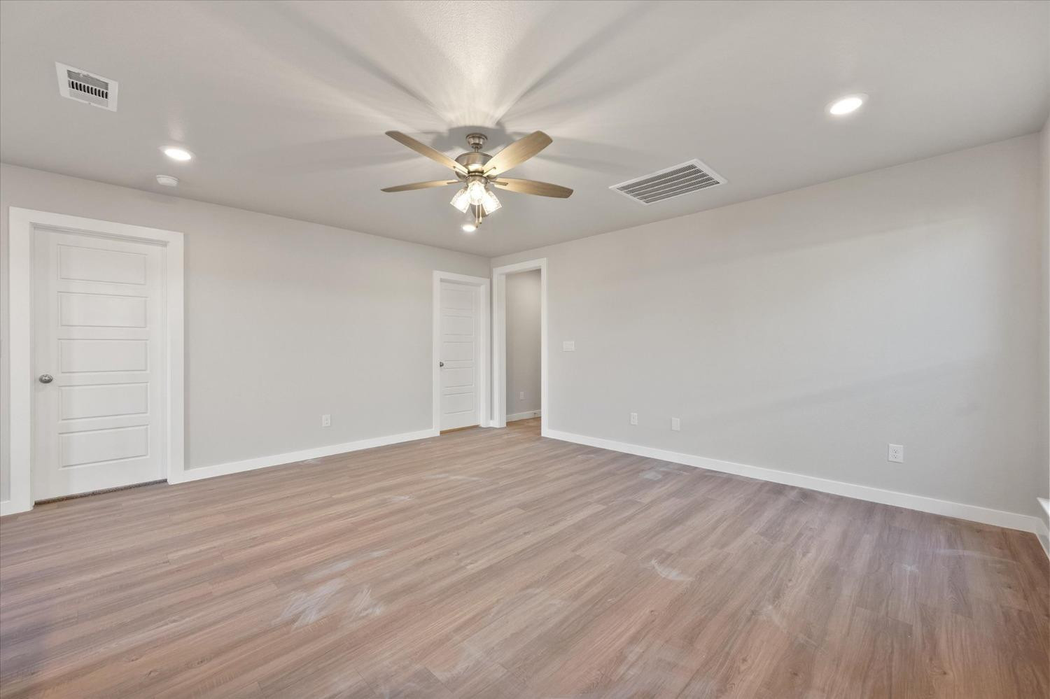 5516 Princeton Street Lubbock, TX 79416 - Photo 5 of 17 a view of an empty room with wooden floor