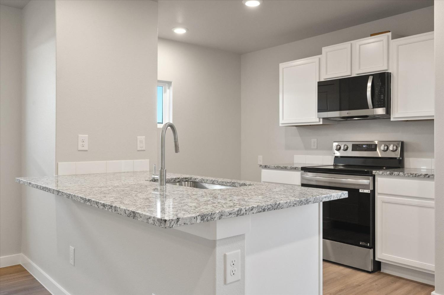 5516 Princeton Street Lubbock, TX 79416 - Photo 8 of 17 a kitchen with stainless steel appliances granite countertop a sink and a stove