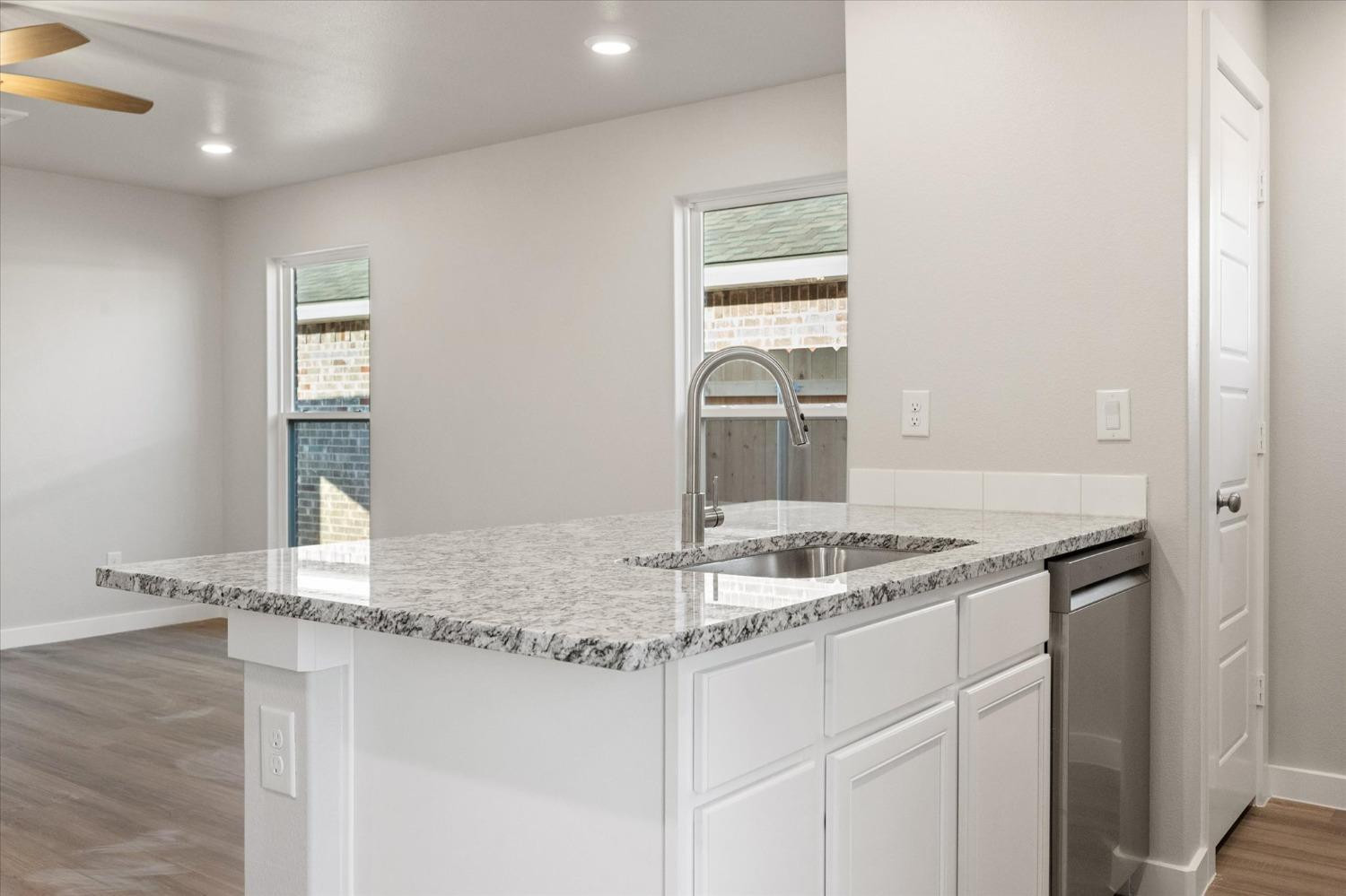 5516 Princeton Street Lubbock, TX 79416 - Photo 10 of 17 a bathroom with a granite countertop sink and a mirror