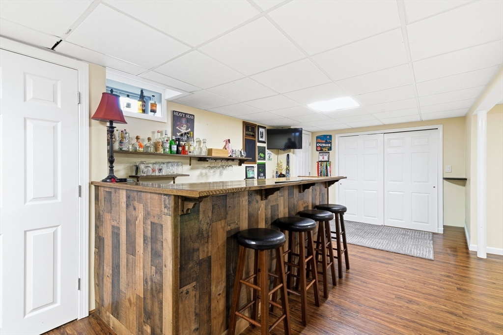 30 Huntington Road Plymouth, MA 02360 - Photo 23 of 35 a kitchen with kitchen island granite countertop wooden floors and refrigerator