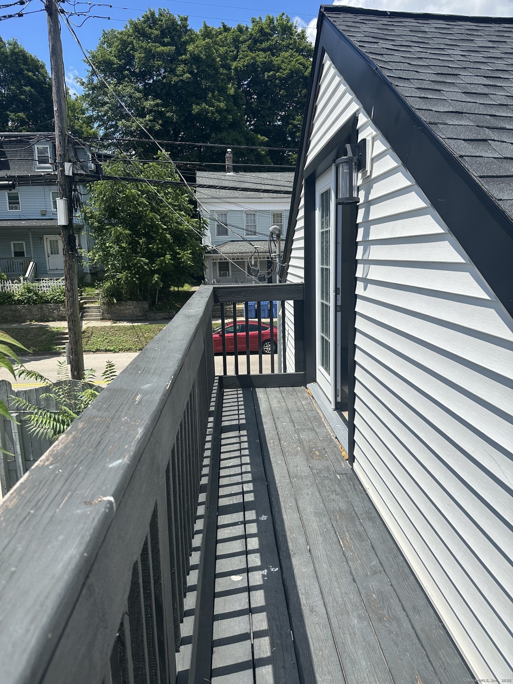197 Central Avenue Norwich, CT 06360 - Photo 12 of 16 a balcony with wooden floor and outdoor seating