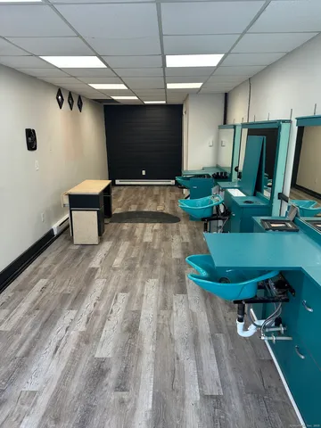 a room with wooden floor pool table and chairs
