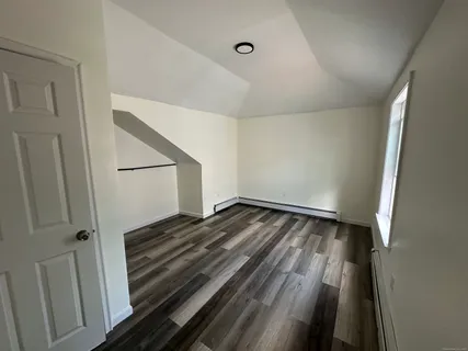 a view of a room with wooden floor
