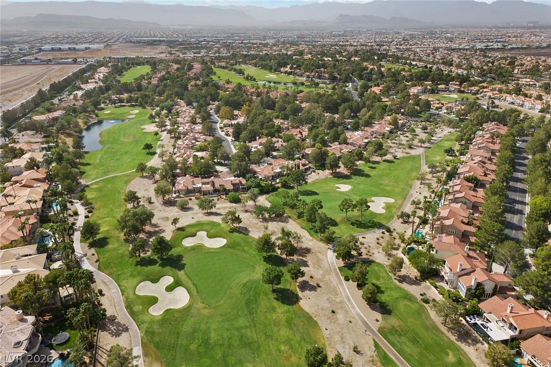 20 Innisbrook Avenue Las Vegas, NV 89113 - Photo 19 of 39 An aerial panorama showcases a meticulously landscaped golf course winding through a vibrant residential community.